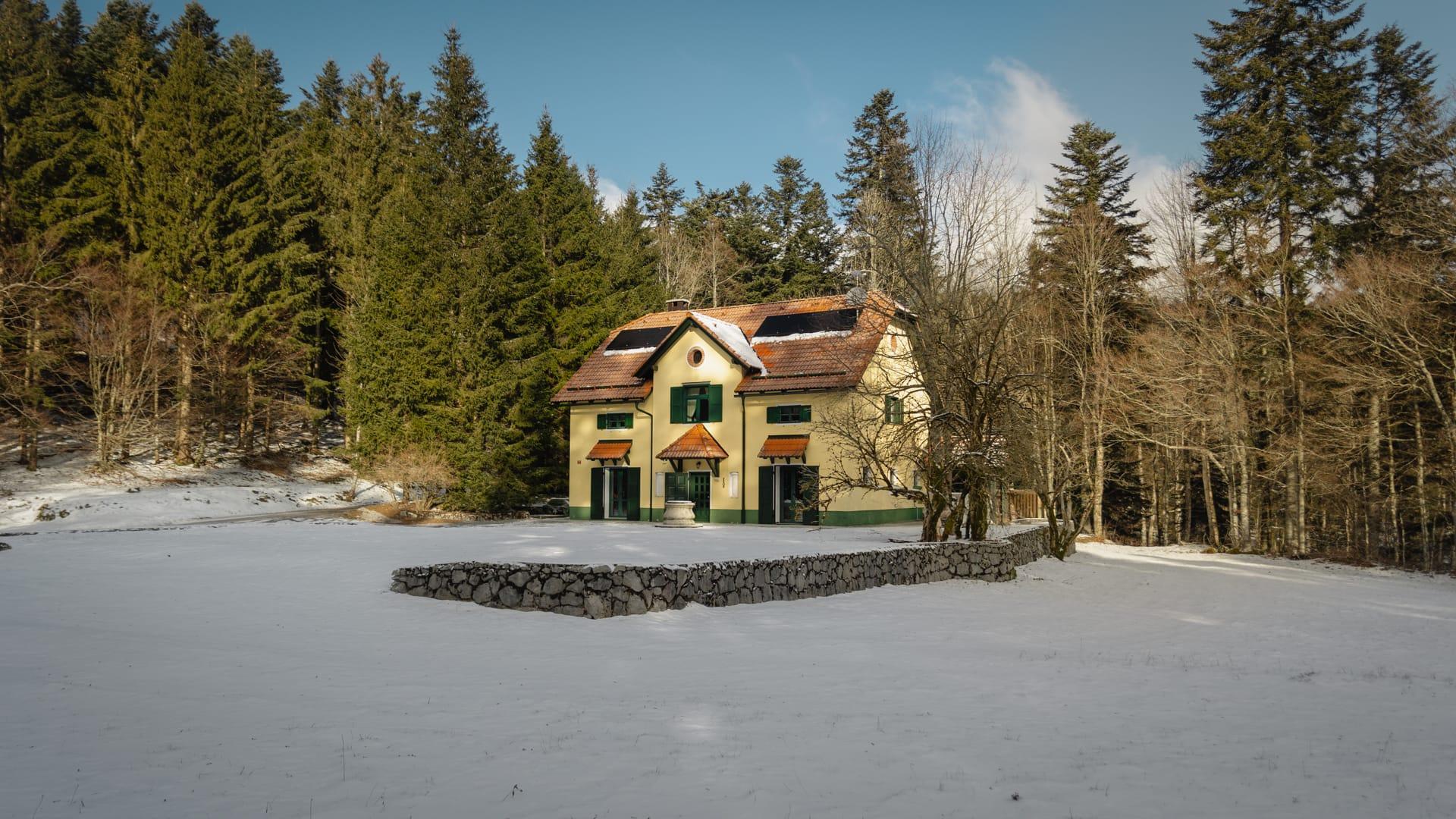 House under Javorniki background