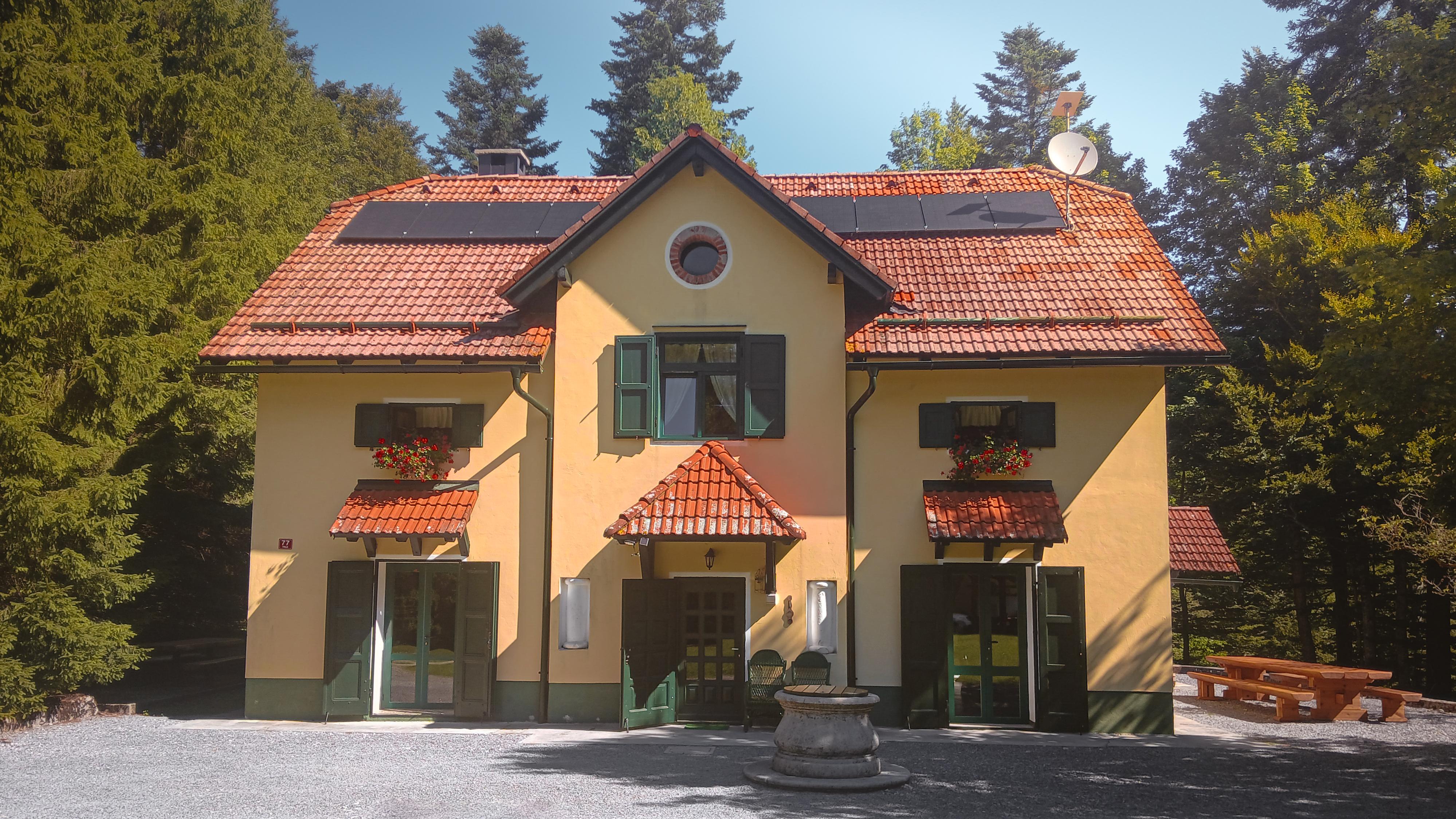 House under Javorniki background